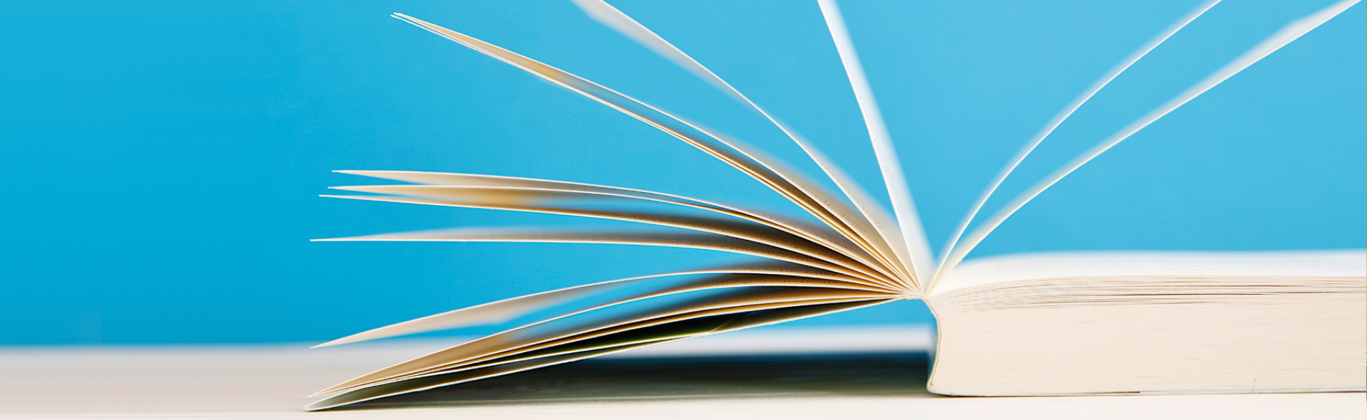An image of an open book against a blue background