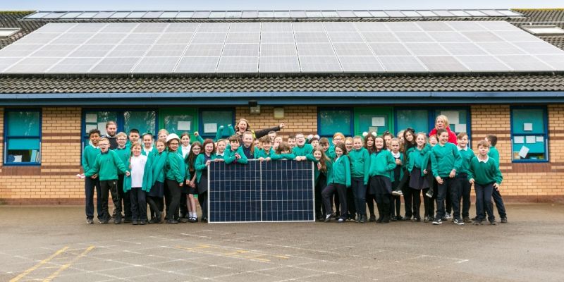 Photo of school children with solar panels