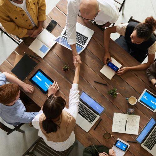 A group of people on laptops studying together
